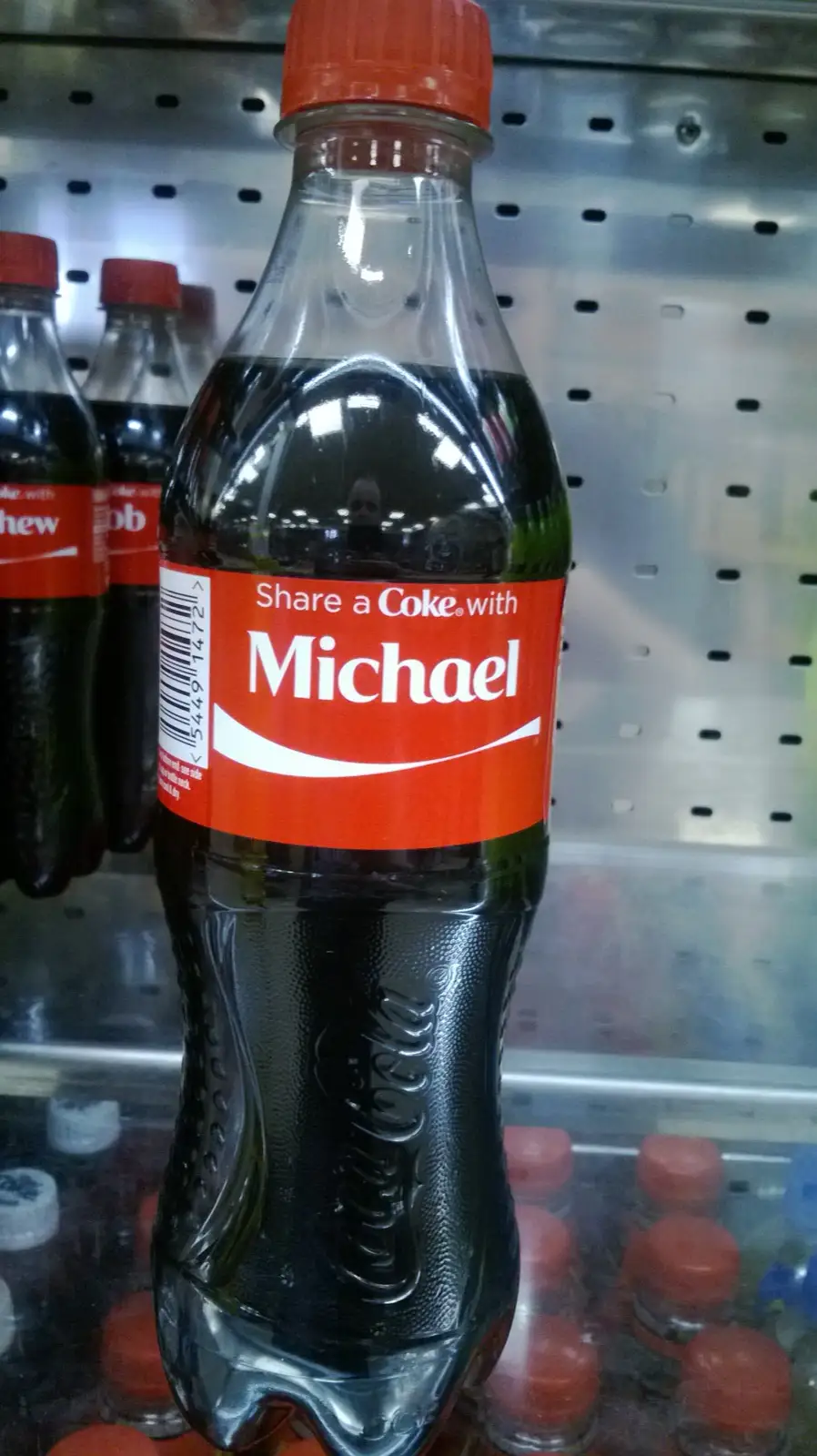A Coca-Cola bottle with a Share a Coke with Michael label on a shop shelf